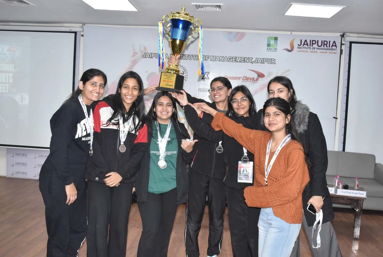 A medal-winning team celebrating with their trophy