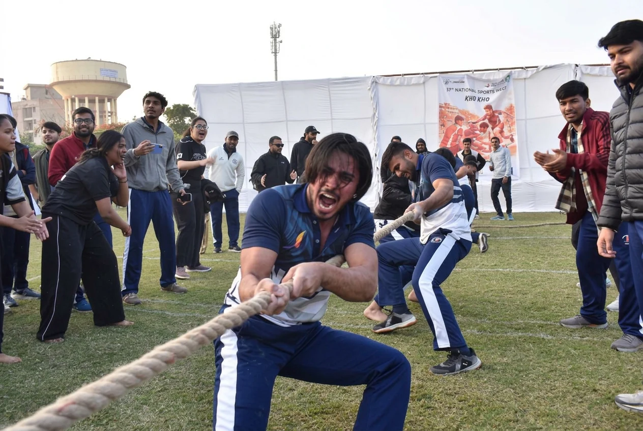 Athletes competing in Tug of War as teammates cheer